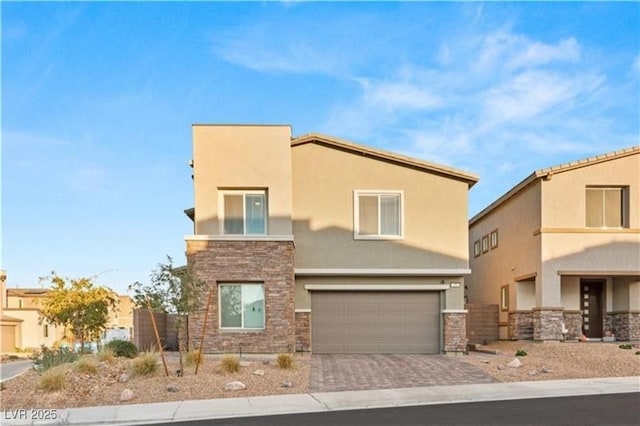 view of front of property featuring stone siding, stucco siding, and decorative driveway