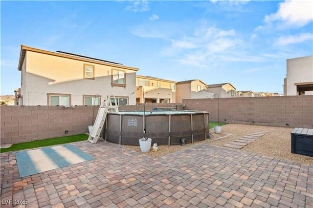 view of patio featuring a fenced in pool and a fenced backyard