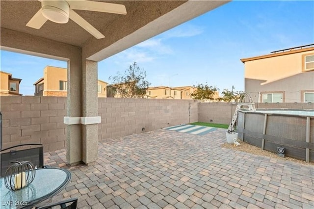 view of patio / terrace featuring a fenced in pool, a fenced backyard, and a ceiling fan