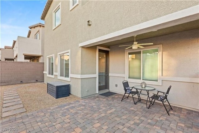 view of patio featuring fence and ceiling fan