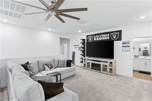 living room with recessed lighting, light colored carpet, and a ceiling fan