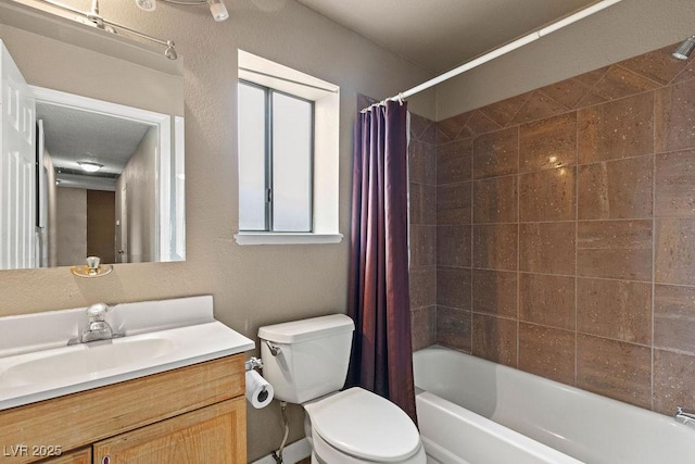 full bath with vanity, toilet, shower / tub combo with curtain, and a textured wall