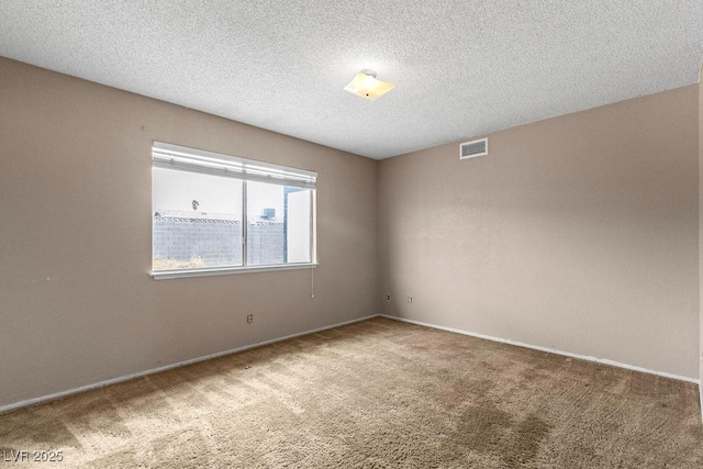 carpeted empty room featuring visible vents and a textured ceiling