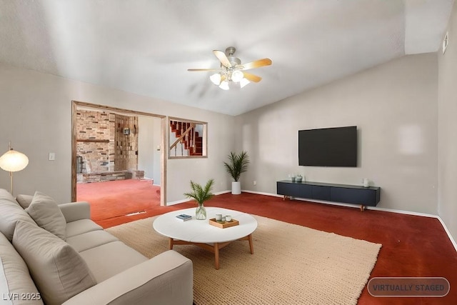 carpeted living room with stairway, baseboards, a ceiling fan, and vaulted ceiling