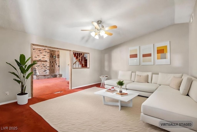 living room featuring lofted ceiling, carpet flooring, baseboards, and ceiling fan