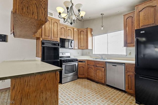 kitchen with a notable chandelier, black appliances, a sink, a peninsula, and light floors