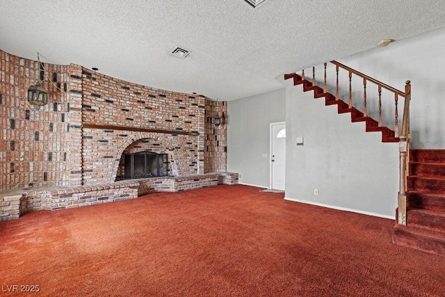 unfurnished living room with visible vents, a textured ceiling, stairway, carpet floors, and a fireplace