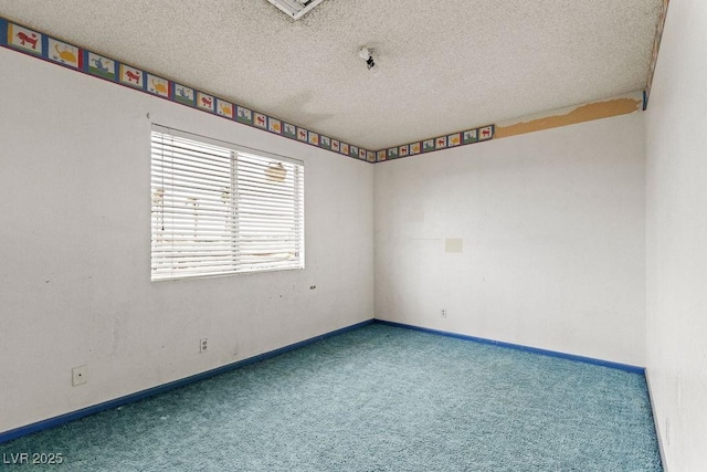 unfurnished room featuring baseboards, carpet floors, and a textured ceiling