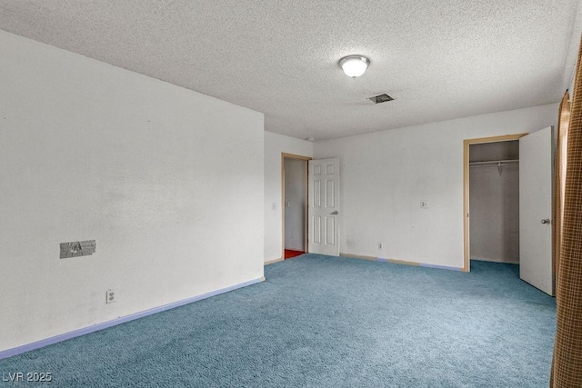 unfurnished bedroom with a closet, carpet flooring, a textured ceiling, and baseboards