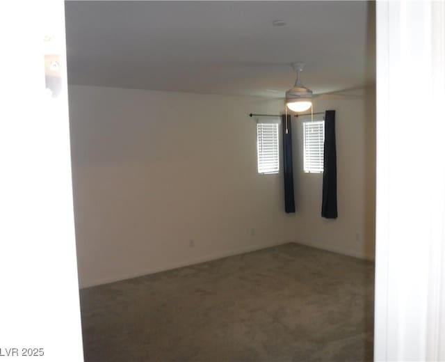 carpeted spare room featuring a ceiling fan