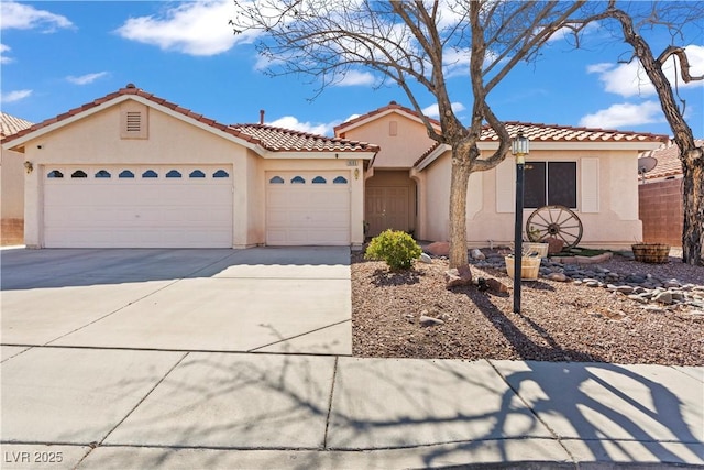 mediterranean / spanish-style home featuring stucco siding, a garage, concrete driveway, and a tile roof