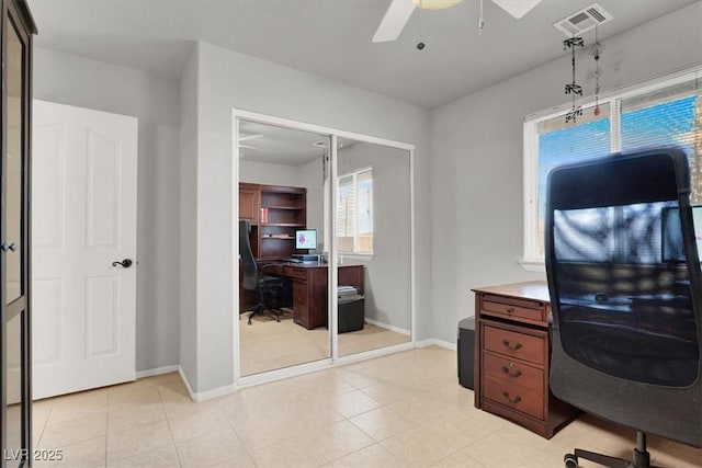 office area with visible vents, baseboards, and ceiling fan