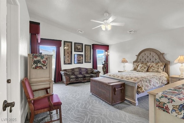 bedroom featuring visible vents, a ceiling fan, lofted ceiling, and carpet floors