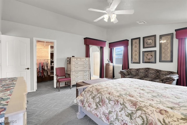 bedroom with visible vents, carpet floors, vaulted ceiling, a closet, and a walk in closet