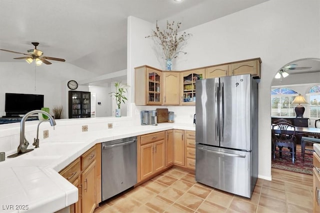 kitchen featuring tile countertops, appliances with stainless steel finishes, and ceiling fan