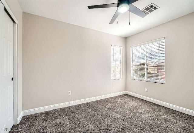 unfurnished bedroom featuring visible vents, baseboards, carpet, and a closet