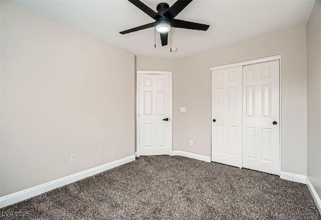 unfurnished bedroom featuring a closet, dark carpet, baseboards, and ceiling fan