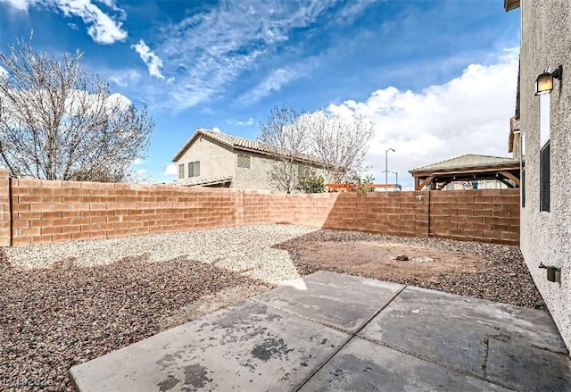 view of yard with a patio area, a gazebo, and a fenced backyard