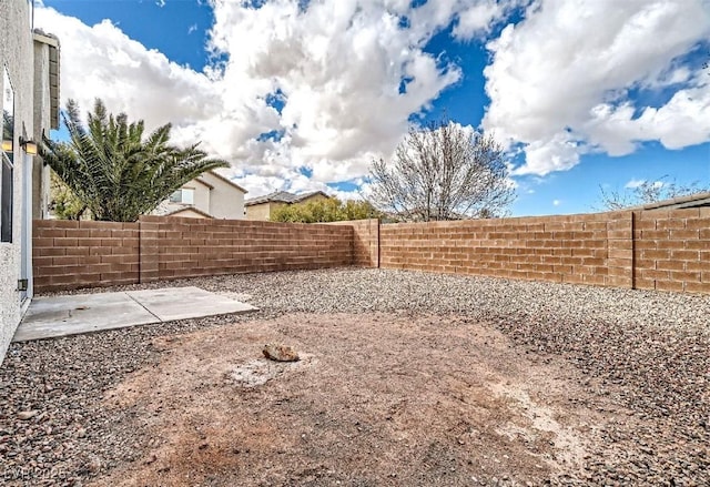 view of yard featuring a patio area and a fenced backyard