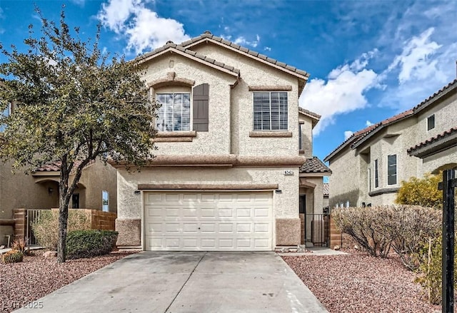 mediterranean / spanish home featuring fence, a tiled roof, concrete driveway, stucco siding, and a garage