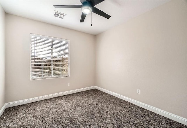 spare room with baseboards, carpet, visible vents, and ceiling fan