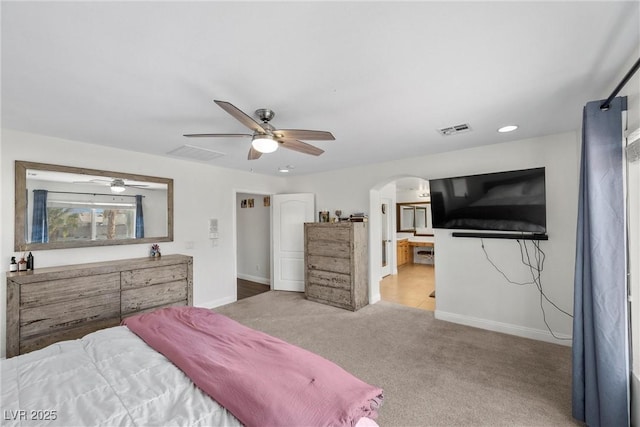 bedroom with arched walkways, carpet flooring, baseboards, and visible vents