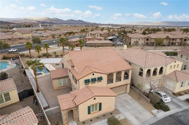 birds eye view of property with a mountain view and a residential view