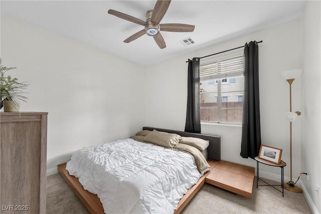 bedroom featuring visible vents, baseboards, ceiling fan, and carpet flooring