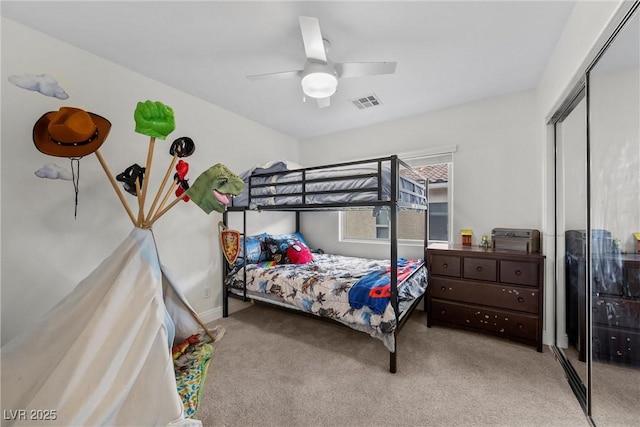 bedroom with visible vents, baseboards, carpet floors, a closet, and a ceiling fan