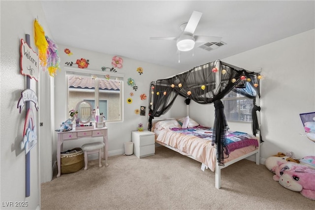 carpeted bedroom with a ceiling fan, visible vents, and baseboards