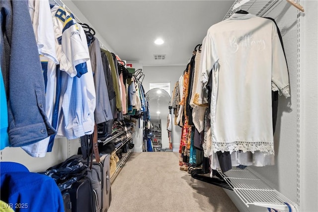 walk in closet featuring visible vents and carpet flooring