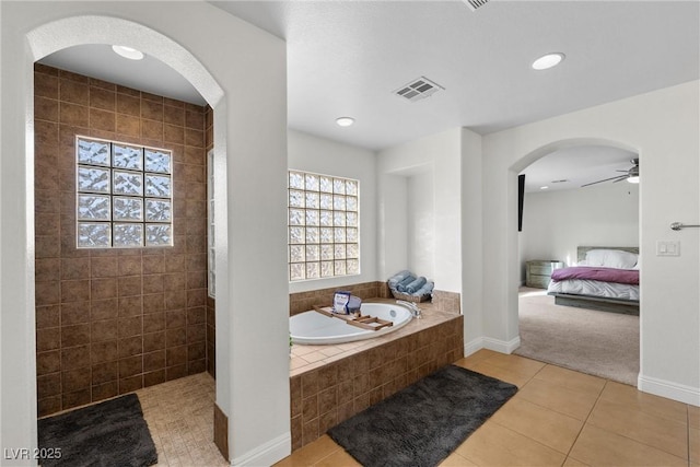 bathroom featuring a garden tub, a ceiling fan, visible vents, tile patterned floors, and connected bathroom