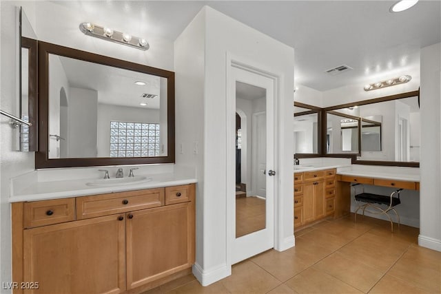 bathroom with a sink, visible vents, two vanities, and tile patterned flooring