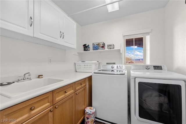 laundry room featuring a sink, cabinet space, and separate washer and dryer