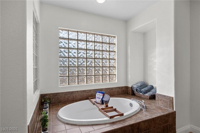 bathroom with a wealth of natural light and a garden tub