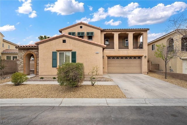 mediterranean / spanish-style home with stucco siding, concrete driveway, an attached garage, a balcony, and a tiled roof