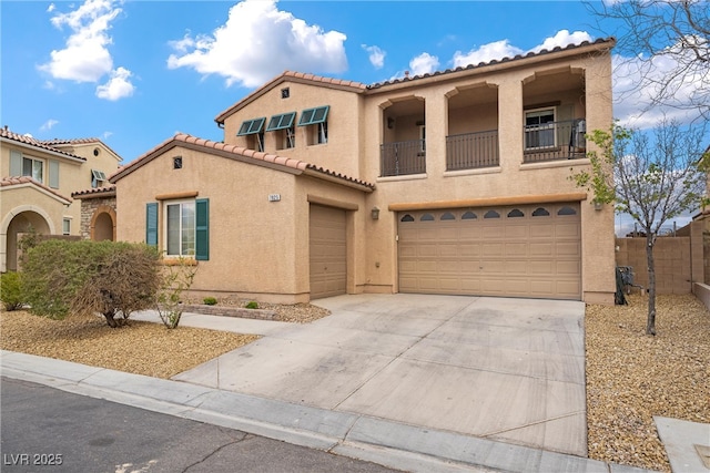 mediterranean / spanish house featuring a balcony, an attached garage, stucco siding, concrete driveway, and a tile roof