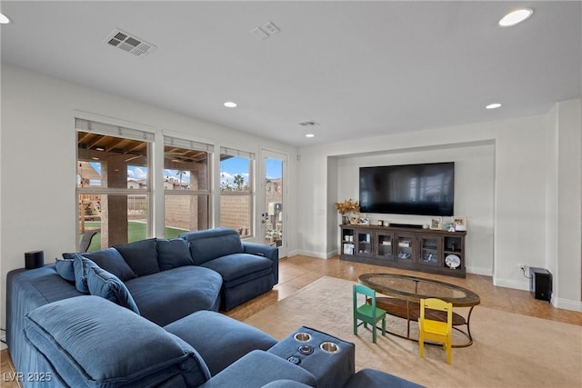 tiled living area with visible vents, recessed lighting, and baseboards