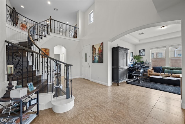 entrance foyer with arched walkways, light tile patterned floors, recessed lighting, and baseboards