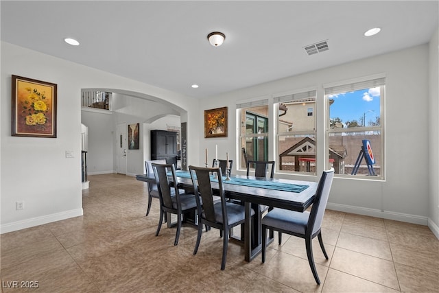 dining room featuring arched walkways, visible vents, recessed lighting, and baseboards