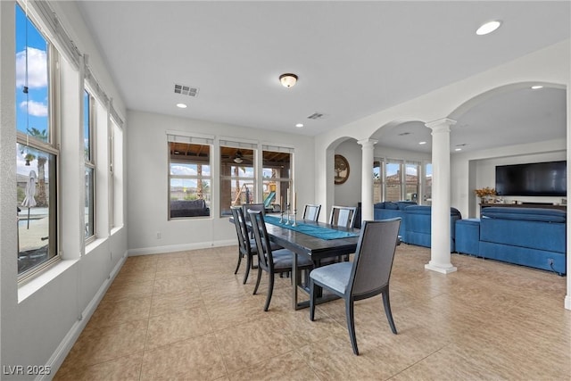 dining room featuring recessed lighting, plenty of natural light, visible vents, and ornate columns