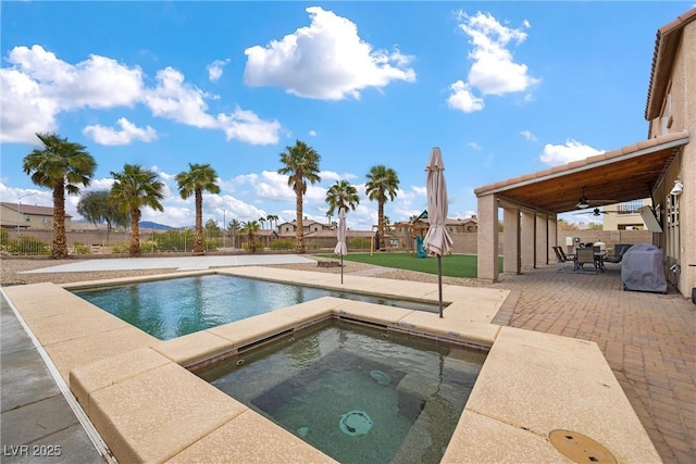 view of pool with a ceiling fan, fence, an in ground hot tub, outdoor dining area, and a patio area