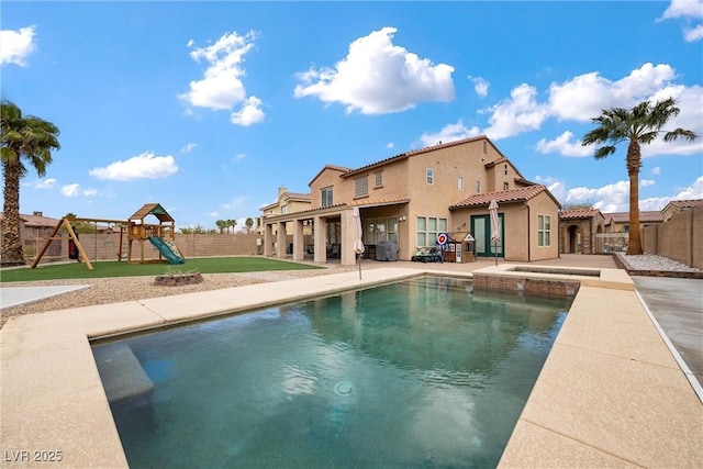 view of swimming pool featuring a patio area, a fenced in pool, a fenced backyard, and a playground