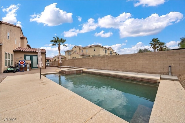 view of pool featuring a patio area, a fenced backyard, and a pool with connected hot tub