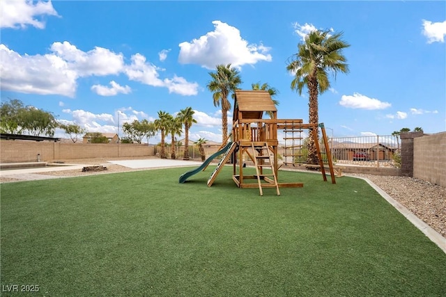 view of play area featuring a lawn and a fenced backyard