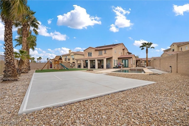 back of house featuring a patio, a fenced in pool, playground community, a fenced backyard, and a tiled roof