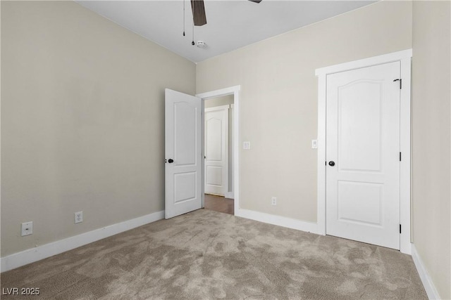 unfurnished bedroom featuring baseboards, carpet floors, and ceiling fan