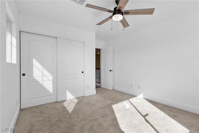 unfurnished bedroom with baseboards, a closet, and carpet floors