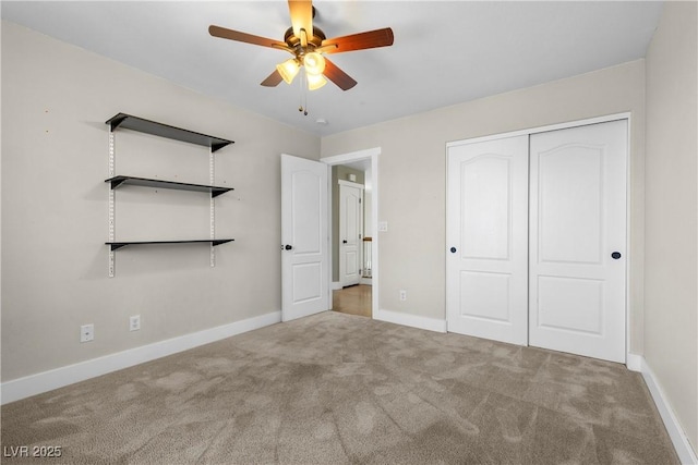 unfurnished bedroom with carpet flooring, baseboards, a closet, and ceiling fan