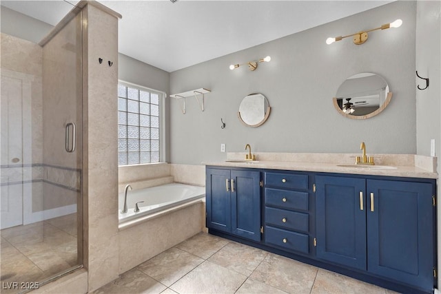 full bathroom with double vanity, a garden tub, a stall shower, and a sink